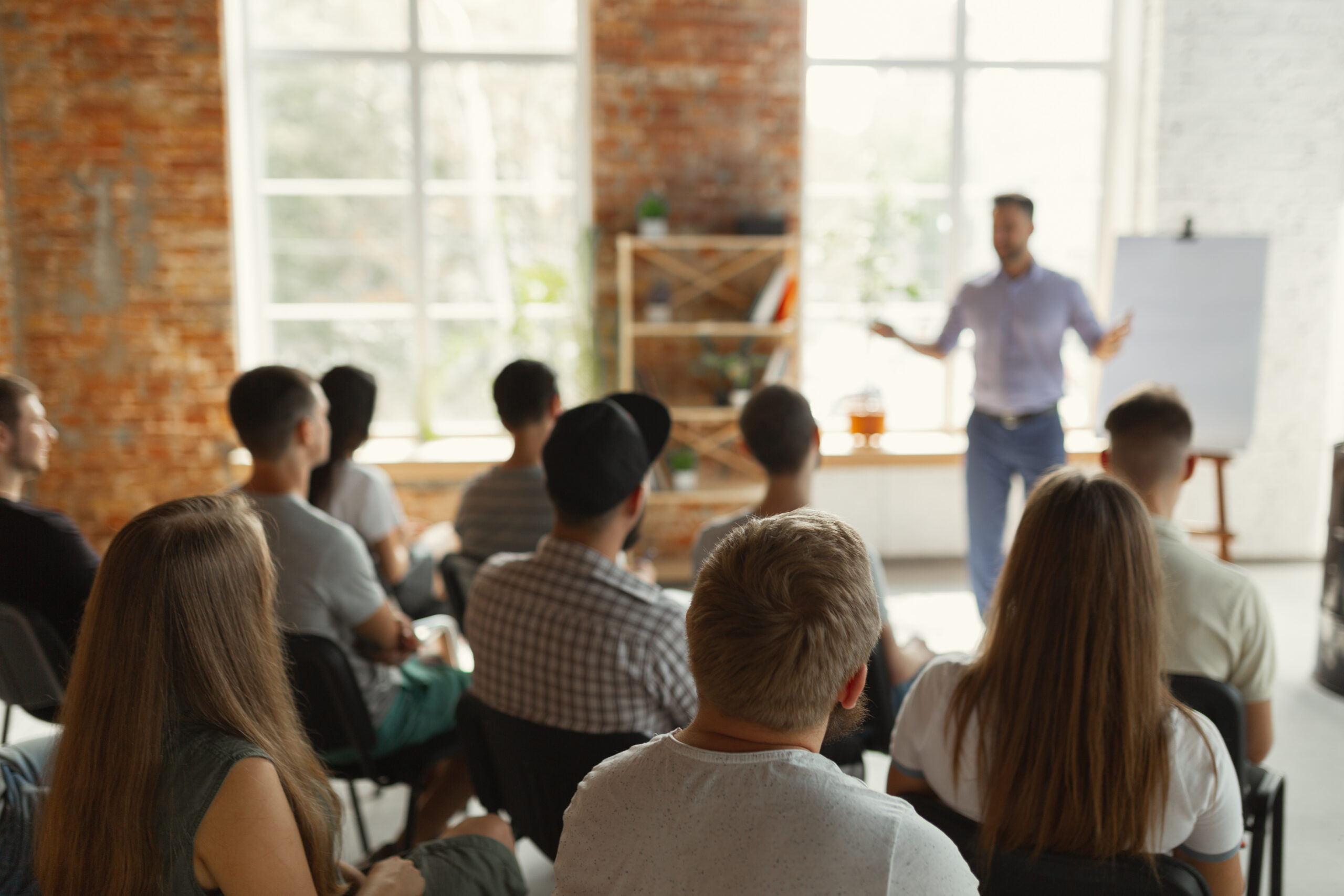 Group of employees listening to presentation while at work