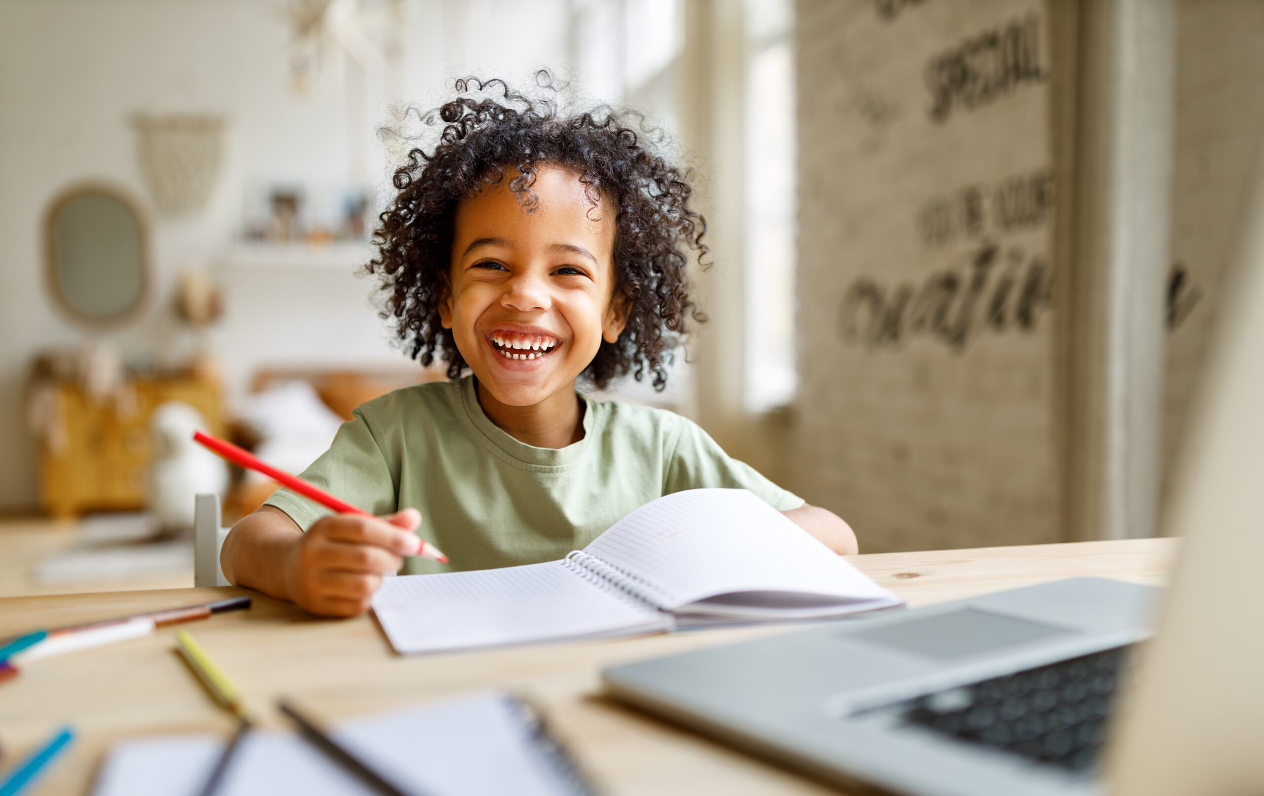 Young student smiling while working in notebook